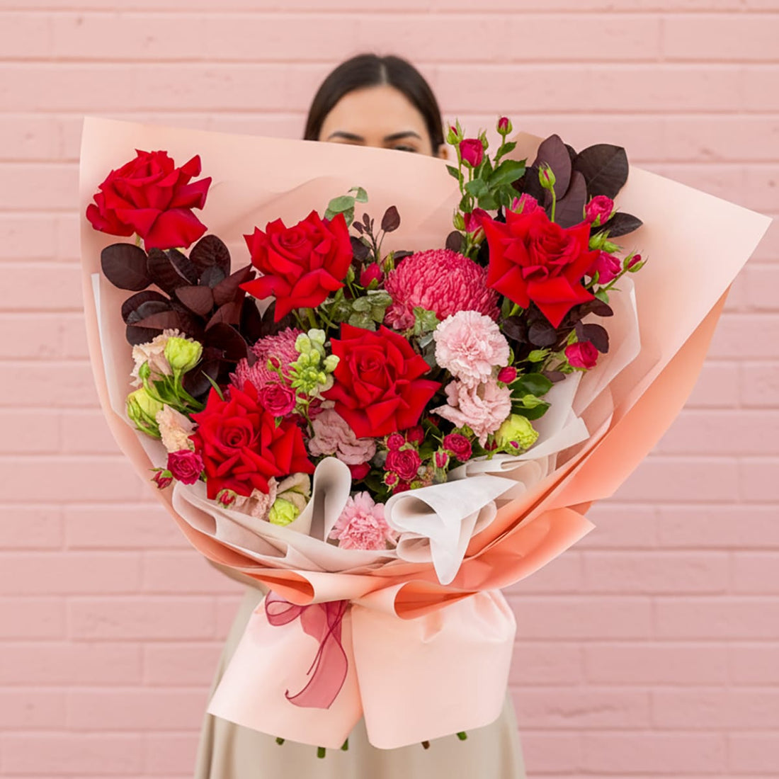 Make their heart skip a beat with our Crimson Crush Bouquet! A stunning mix of red roses, mums, and carnations for Valentine&